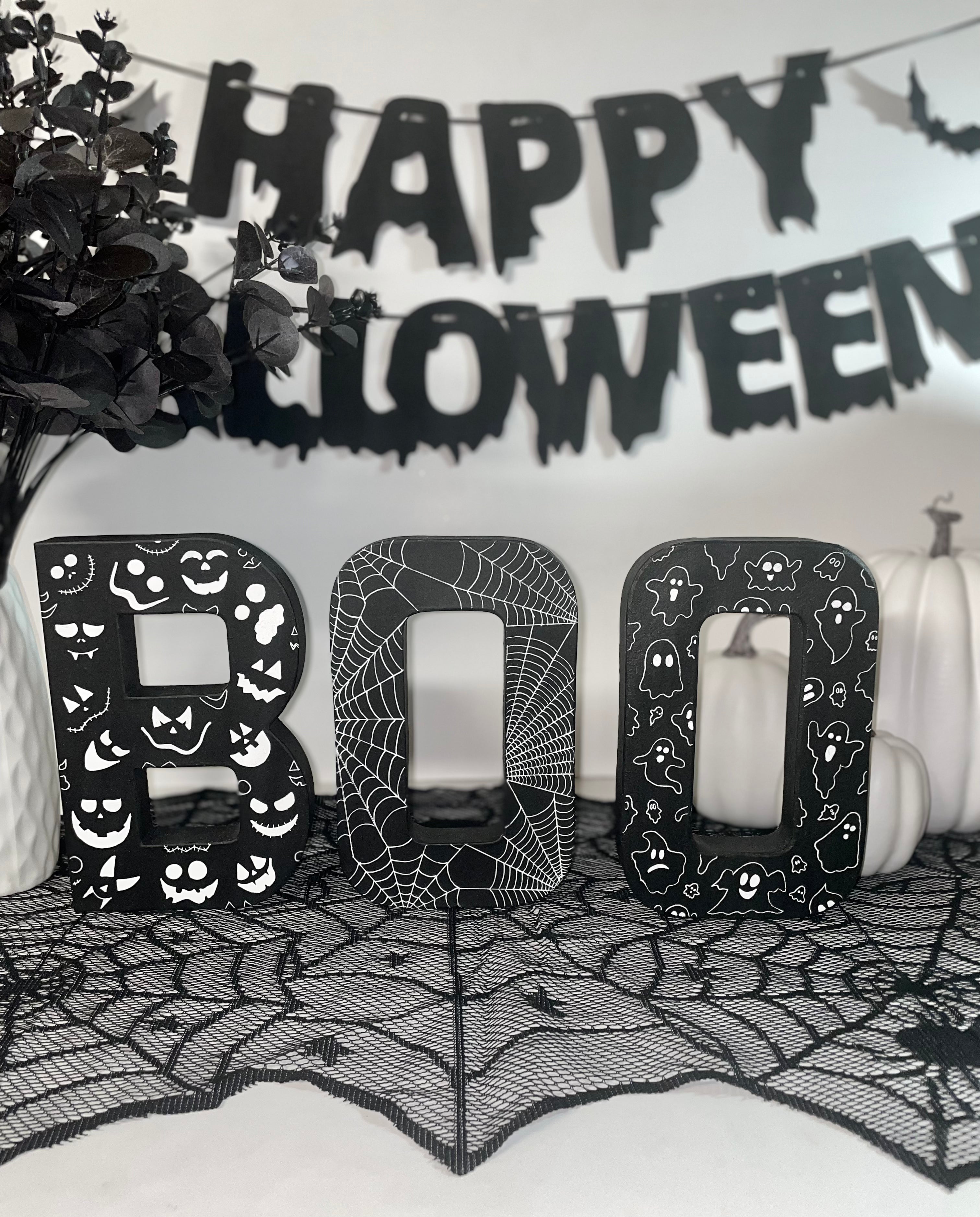 Black BOO Letters Decorated with white Pumpkin Faces, Spider Webs & Ghosts. Halloween Party Sign Decor. Freestanding Letters