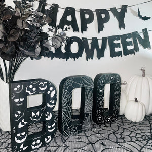 Black BOO Letters Decorated with white Pumpkin Faces, Spider Webs & Ghosts. Halloween Party Sign Decor. Freestanding Letters