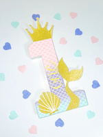 Load image into Gallery viewer, Mermaid themed number &#39;1&#39; with a gold glitter crown, tail and shell on a white background with pastel confetti hearts scattered.
