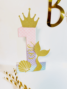 Mermaid themed number '1' with a gold glitter crown and tail on a white background